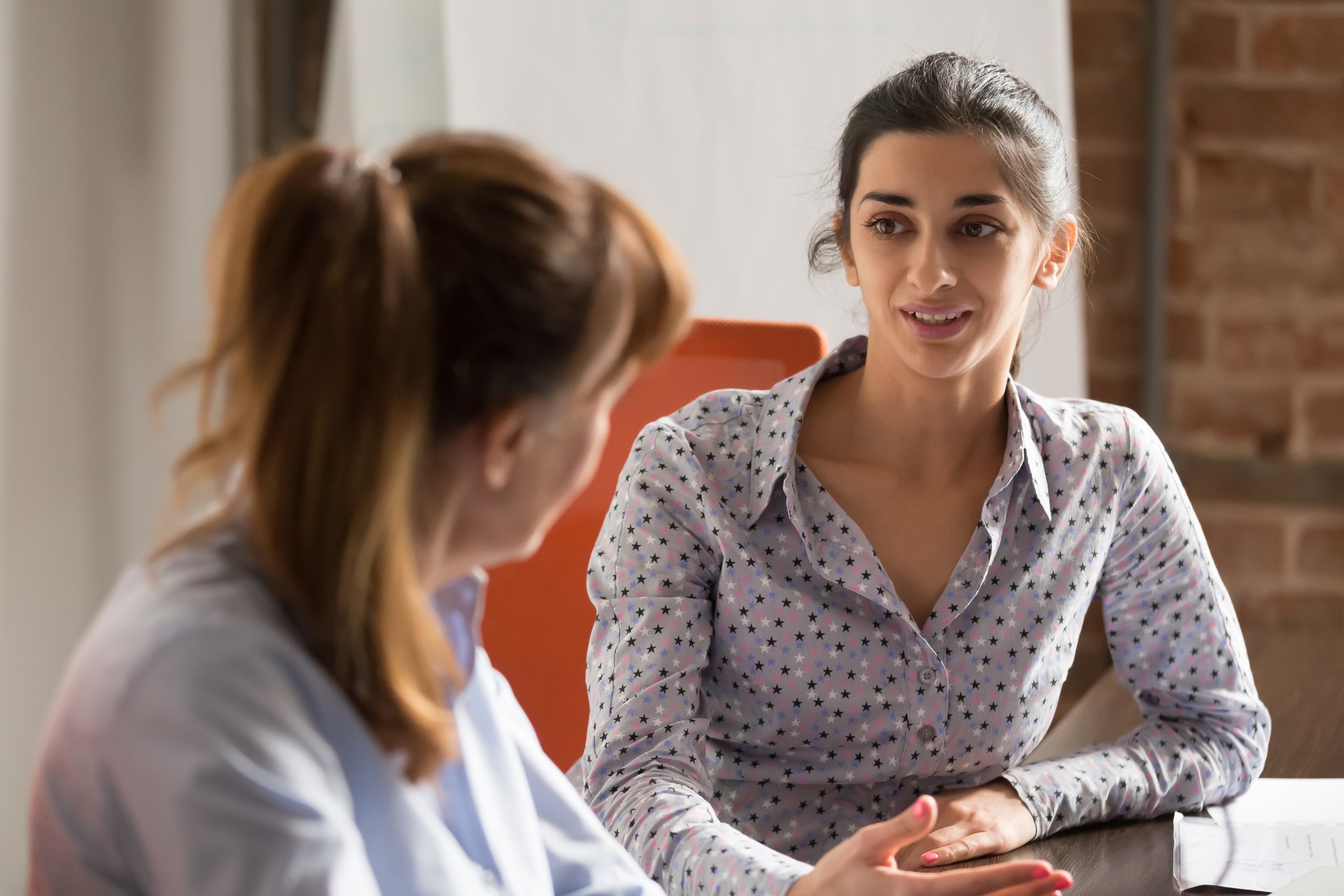 Indian businesswoman speaking consulting client at business office meeting