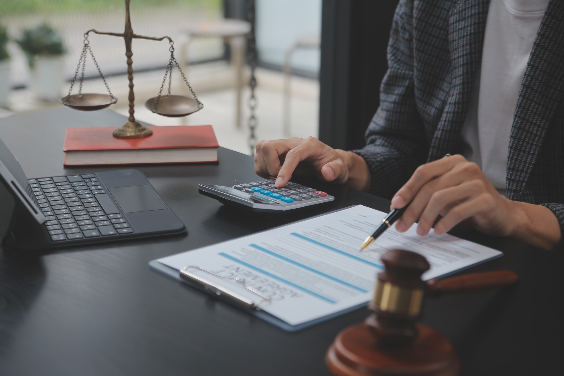 Business and lawyers discussing contract papers with brass scale on desk in office. Law, legal services, advice, justice and law concept picture with film grain effect